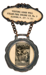 1911 FIRE BADGE WITH CELLULOID ADVERTISING "WARNER'S RUST-PROOF CORSETS."