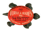 CAST IRON TURTLE WITH ADVERTISING ON CELLULOID SHELL.