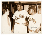 SATCHEL PAIGE AND MINNIE MINOSO TALKING TO REPORTER NEWS SERVICE PHOTO.