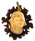 GRANT AND COLFAX 1868 CARDBOARD PHOTO HELD IN WALNUT SHELL CROSS SECTION PENDANT.