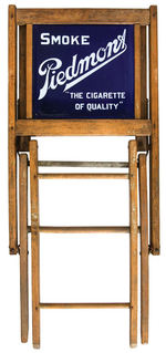 “SMOKE PIEDMONT/THE CIGARETTE OF QUALITY” PORCELAIN-BACKED FOLDING CHAIR.