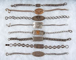 WORLD WAR II SERVICEMEN’S COLLECTION OF SEVEN STERLING AND ONE GOLD FILLED BRACELETS.