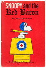 "SNOOPY AND THE RED BARON" SIGNED FIRST EDITION BOOK W/DRAWING BY CREATOR CHARLES M. SCHULZ.