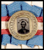 "A. LINCOLN" SCARCE 1864 FERROTYPE STICKPIN MOUNTED ON ELABORATE PATRIOTIC COCKADE WITH ARM BANDS.